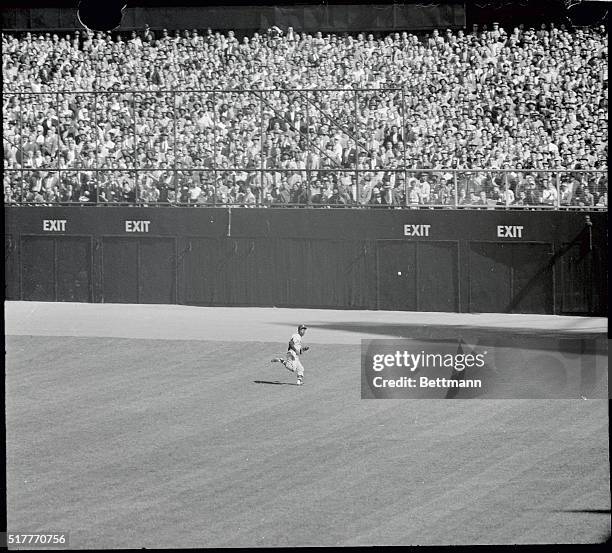 Hank Aaron of the Braves chases Bauer's hit to centerfiled, scoring Coleman from 3rd base in the fifth inning of series opener with the Yanks today....