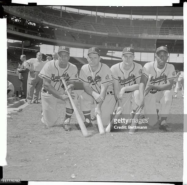 This is a foursome of doughty outfielders of the Milwaukee Braves showing off their war clubs and rarin' to meet the New York Yankees or anyone else...