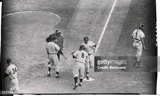 Mickey Mantle of the Yanks is Welcomes at plate by Yogi Berra after blasting 1 2-run homer over the center field wall in the fourth inning. Yanks...