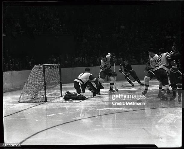 Terry Sawchuck , Detroit Red Wings goalie, makes a save to spoil Danny Lewicki's scoring attempt in the third period of tonight's game with the...