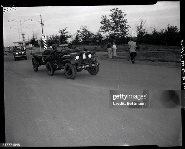 Two Negro soldiers of the 101st Airborne Division now guarding strife-torn Little Rock Central High School drive their jeep in the direction of the...