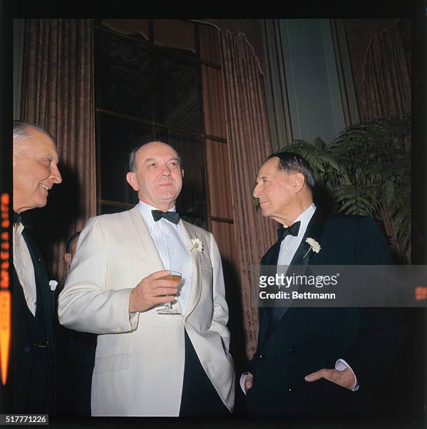 Left to right are Dean Rusk and General MacArthur, at the Time Magazine's 40th anniversary dinner. Third man unidentified.