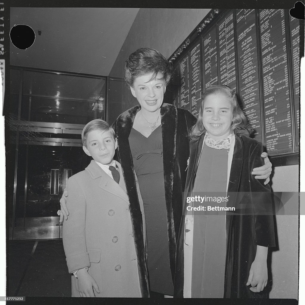 Singer Judy Garland is flanked by her children, Joseph and Lorna, as