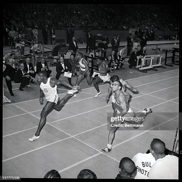 Streaking Bob Hayes of Florida A&M breaks the tape to set a world indoor record of 5.9 seconds for the 60-yard dash, February 22, in the National AAU...