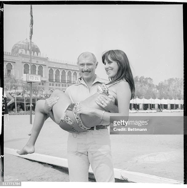 Nice Carry. Venice, Italy: American actor Lee Van Cleeft seems to find French starlet Elisabeth Juaret Browie no weight problem as he carries her on...