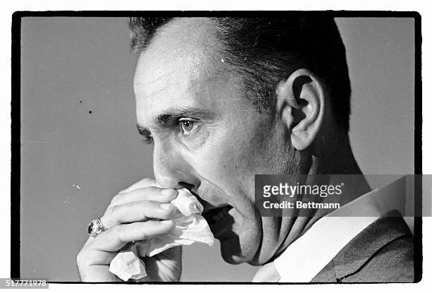 Former big league basketball star Bob Cousy, now a basketball coach for Boston College, wipes tears from his eyes during a news conference here...