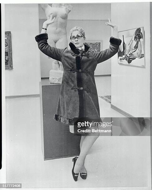 Museum Caper. Amsterdam, Holland: Actress Candice Bergen throws up her hands in mock despair before a statue of the famed Grecian lady in Amsterdam's...