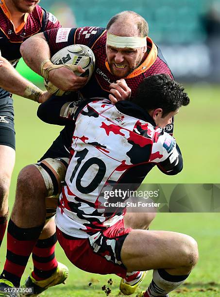 Phil Burleigh of Edinburgh tackles Dragons player Cory Hill during the Guinness Pro 12 match between Newport Gwent Dragons and Edinburgh Rugby at...