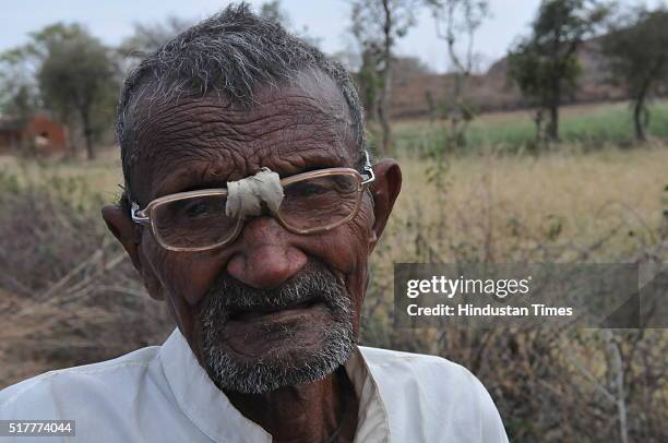 An old farmer Babu Rajak in tears after explaining to the tehsildar the details of damage to his crops by hail near Jatara on March 17, 2016 in...