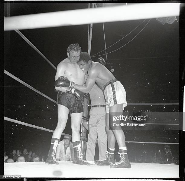 Ernie Terrell of the United States drapes himself over Mexican heavyweight hope Manuel Ramos in a ten rounder here which Ramos won by unanimous...