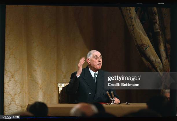 French President Charles de Gaulle gestures during a press conference in Paris November 27th. He fiercely attacked the dollar and called for a return...