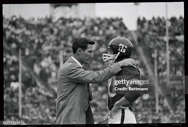 Texas A & M head coach consults one of his Aggies during their 1968 Cotton Bowl game against Alabama.