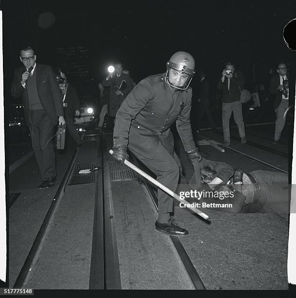 Police drag demonstrator to the paddy wagon, after they broke up demonstrations, staged by more than 500 persons outside the Fairmont Hotel, in...