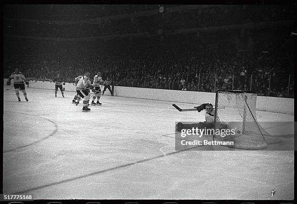 Boston Bruin's goalie Ed Johnston looks at puck that just sailed past him off the stick of Chicago Black Hawk's Bobby Hull , during the 2nd period of...