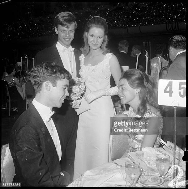 Barbara Anne Eisenhower and her escort, Don Stolper table hop at the International Debutante Ball at the Waldorf December 28th, to visit her brother...