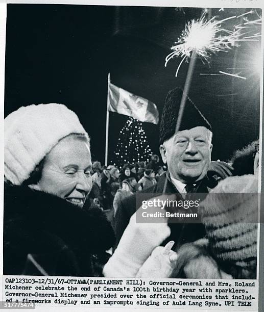 Ottawa, Canada - Governor-General and Mrs. Roland Michener celebrate the end of Canada's 100th birthday year with sparklers. Governor-General...