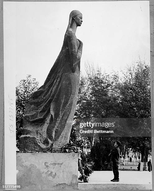 Little boy stands admiring the monumental statue of actress Nurkhon Yuldasheva located in Margilano. She was the first woman in this republic who...