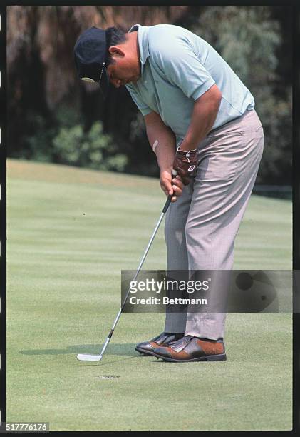 Lee Trevino putts out on the 5th hole during third round of the Masters tourney, 4/12. He was three over par for the day.