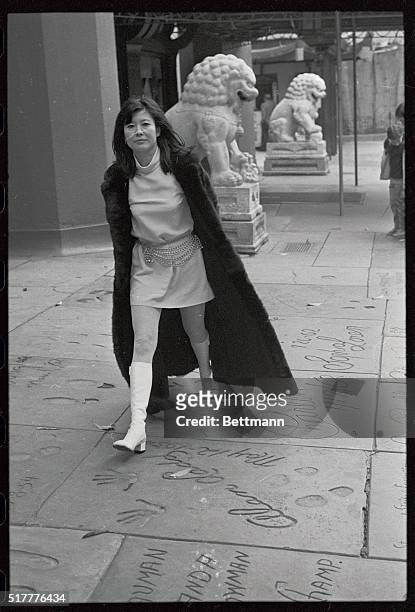 The star of Columbia Pictures' The American Soldiers, strolls past the "Heavenly Dogs" at Grauman's Chinese Theater. The replicas of Ming Dynasty...