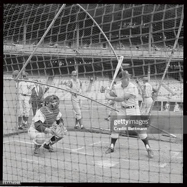 Yankee Manager Yogi Berra fills in as catcher during a batting practice in Yankee Stadium May 17, before meeting the Kansas City A's in a...