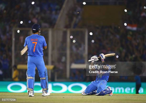 Dhoni, Captain of India and Virat Kohli of India celebrate victory during the ICC WT20 India Group 2 match between India and Australia at I.S. Bindra...
