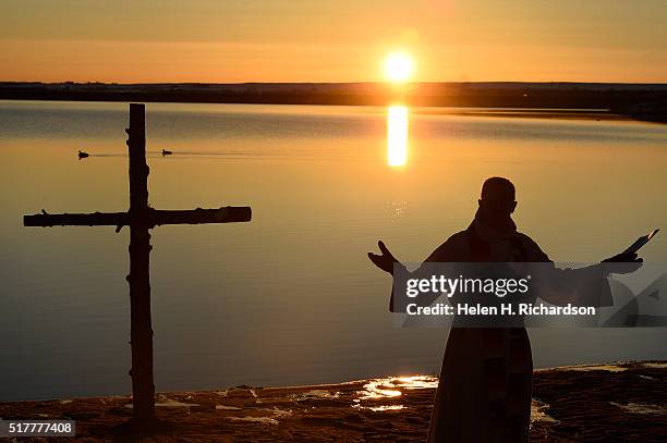 Reverend Mark Twietmeyer, of Trinity Lutheran Church, leads the 21st annual Easter sunrise celebration service just as the sunrises on the shores of...