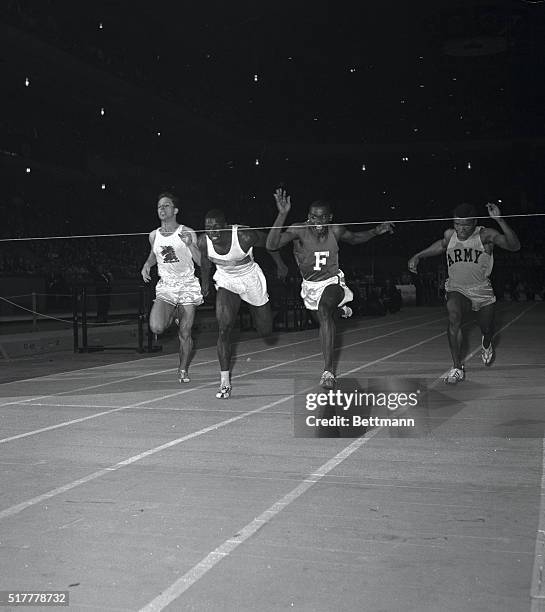 Muscular Bob Hayes , of Florida A&M, leans forward to break tape with his nose as he wins, 60 yard dash event of the Wanamaker Millrose games in...