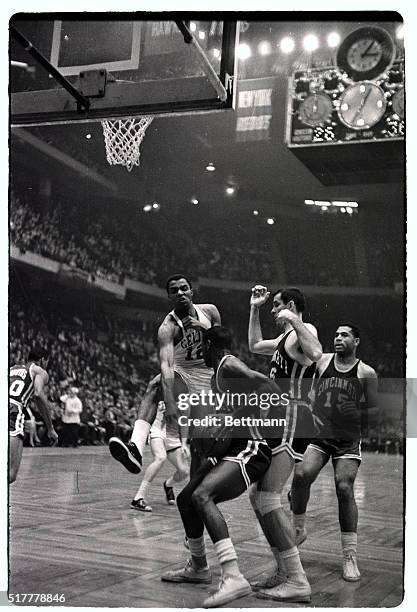 Celtics' Willie Naulls leaps high as he guards against Royals' Oscar Robertson during Royals-Celtics action, Boston Garden, 2/2. Royals' Jerry Lucas...