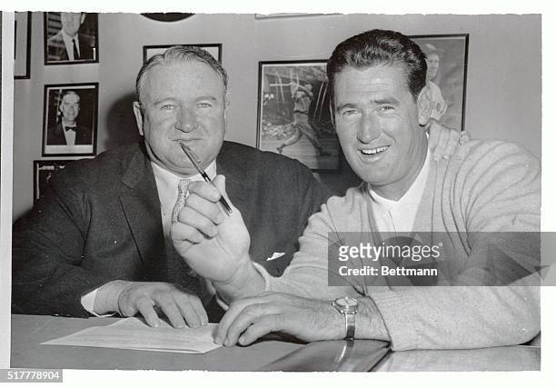 Ted Williams, 39 year old slugging ace of the Boston Red Sox, looks understandably pleased with himself after he signed his 1958 contract with the...