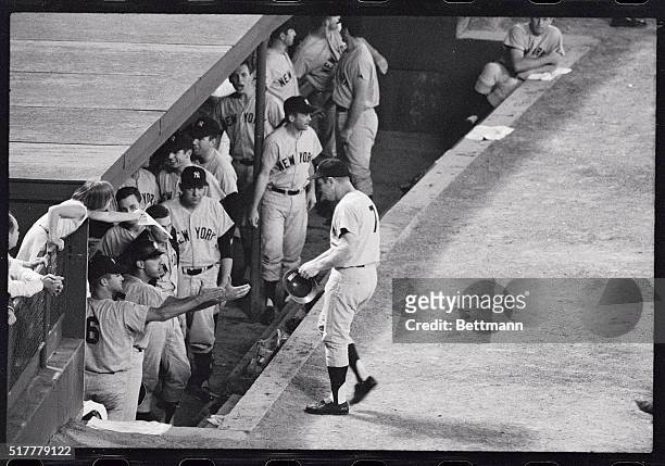 New York slugger Mickey Mantle returns to the dugout after hitting his 13th homerun of the year in the sixth inning against Washington tonight. The...
