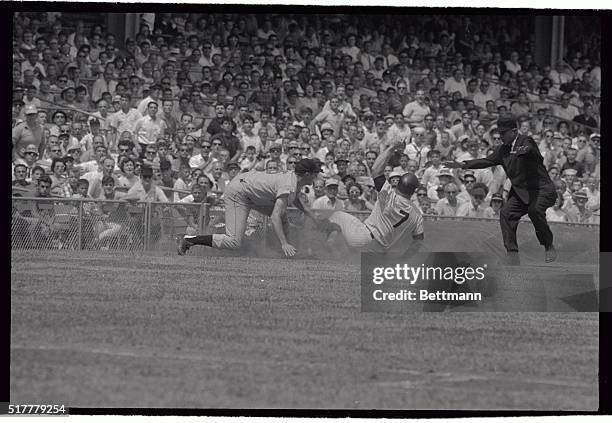 Mickey Mantle of the New York Yankees is safe at third on the front end of a successful double steal in the second inning of the July 15th game with...