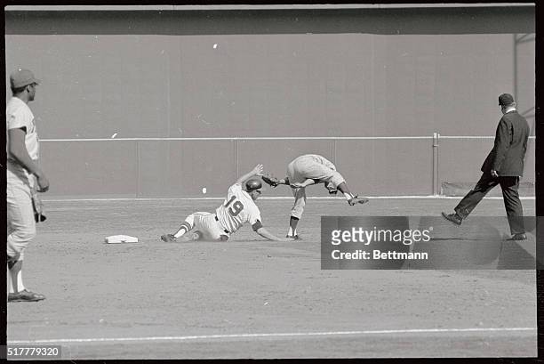 Phillies 2nd base man Cookie Rajas is nearly "bent out of shape" as he vaults over Braves Dennis Mense. Mense was forced on a grounder to short, but...