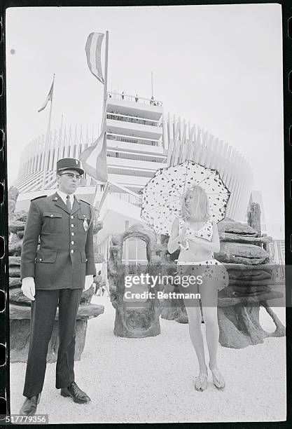 No Heed. Montreal, Canada: This Expo 67 guard certainly has no reason to frown. Sabrina, from the French Pavilion here , is trying out her new bikini...