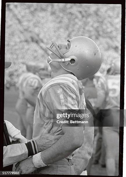 Quarterback Gary Beban throws his head back in pain as he gasps for air after he reinjured his ribs on a hard tackle by the trojans. UCLA was...