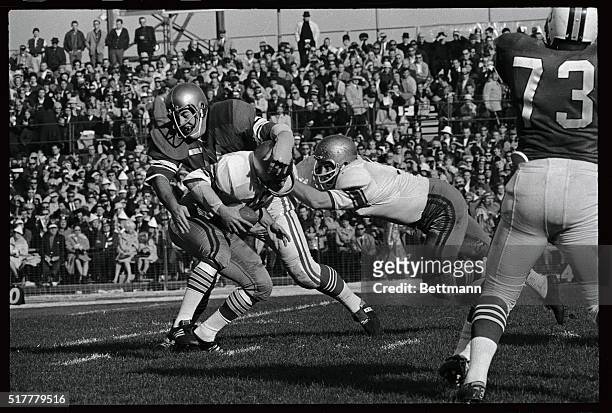 West's QB Gary Beban, UCLA, the 1967 Heisman Trophy winner is swarmed on by East defensive end Kevin Hardy of Notre Dame, in 2nd quarter of 43rd...