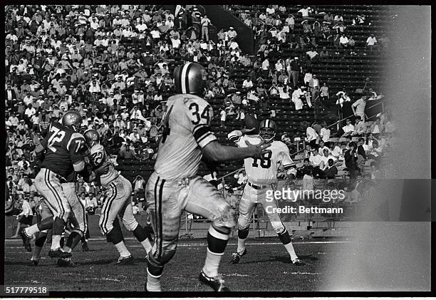 Photo shows two Ram teammates, quarterback Roman Gabriel and halfback Lester Josephson team up to give the West 10 years in the third quarter on a...