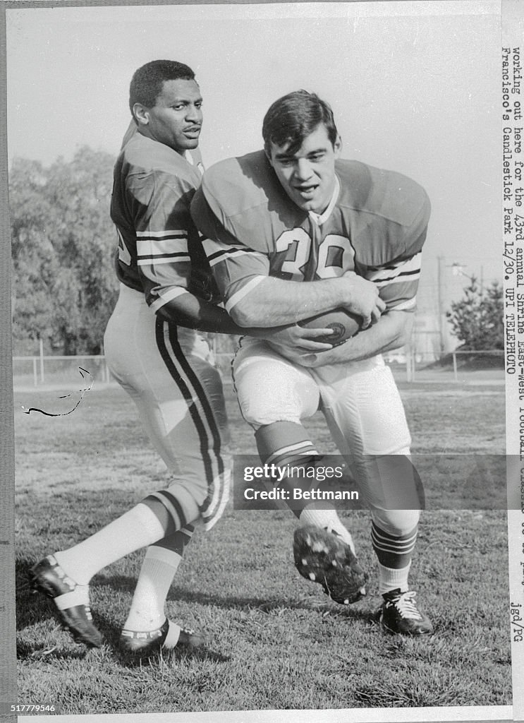 Football Players Practicing for Upcoming Game