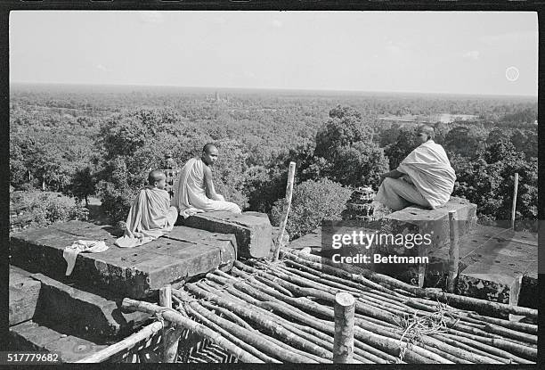 Angkor-Jewel of the Jungle. Angkor, Cambodia: A trio of Buddhist monks sits atop Phnom Barkheng, built by Khmer King Yacovarman during his reign...