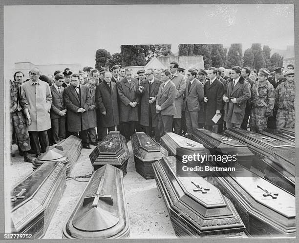 Italian Premier Aldo Moro and other officials pay final respects to victims of last week's earthquake on January 20th. Moro began a tour of the...