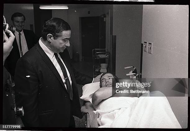 Jockey Willie Shoemaker, America's famed stakes rider, lies on a stretcher at Arcadia Methodist Hospital, and is visited by a visitor, after breaking...