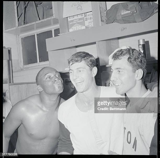 Red Sox infielder George Scott gets ready to plant a big one on teammate Carl Yastrzemski in the locker room of Cleveland Municipal Stadium after...