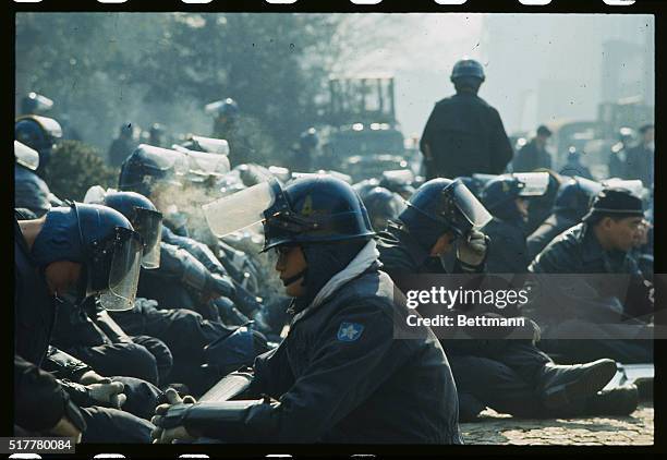 Some of the more than 8,500 policemen taking part in an 11-hour battle with radical Tokyo University students rest during the fighting. The radicals...