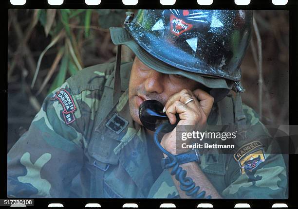 Marine working with South Vietnamese Rangers who are in a cemetery where they fought with Communists for two hours on the fifth day of the...