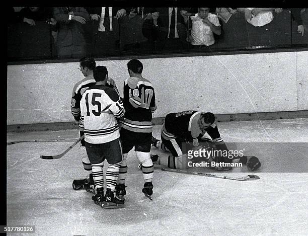 Bruins' Ken Hodge kneels over teammate Bobby Orr, who was knocked out by Leaf's Pat Quinn, second period. Fans tried to get at Leafs' Quinn in the...