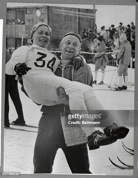 Coach Ake Frederiksson of the Swedish team jubilantly carries Toini Gustafsson here after they upset the Russians in the women's five-kilometer cross...