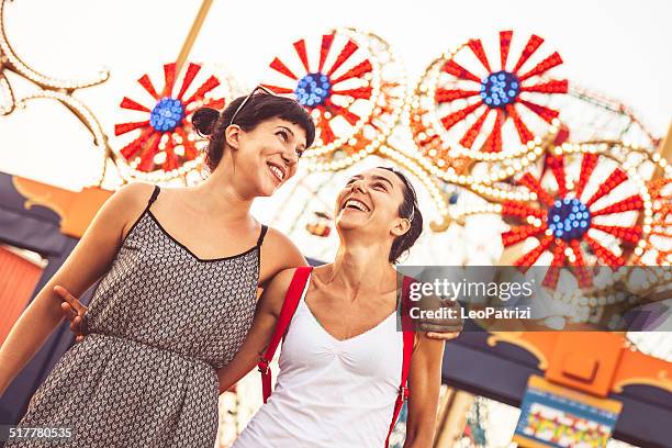 two friends at amusement park - luna park stock pictures, royalty-free photos & images