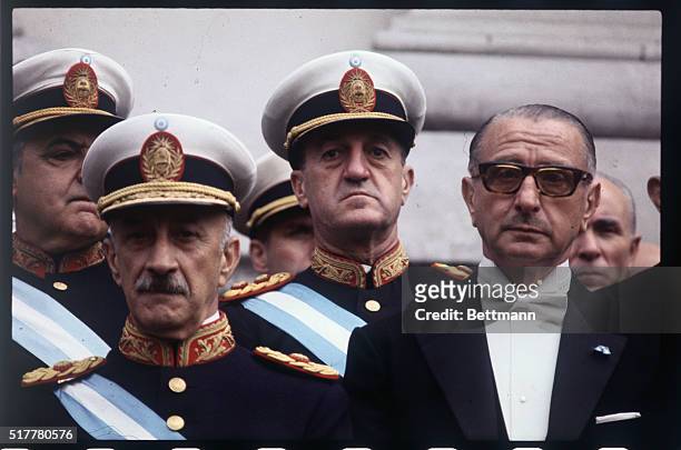 Argentine President Juan Carlos Ongania, stands with Finance Minister Adalberto Krieger Vasena, ; in the back of them and center is General Gustave...