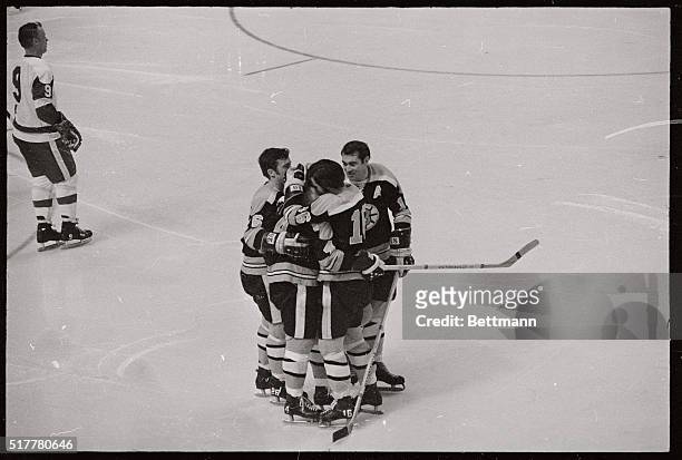 Bruin's Bobby Orr is embraced by teammates Don Awrey , Derek Sanderson, , and Ed Westfall, , after Orr became the first defense man in NHL history to...