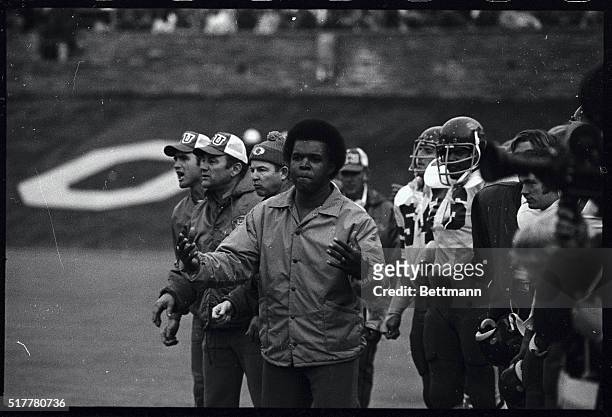 Former Chicago Bears football great Gale Sayers appears to be leading the Kansas bench with a cheer during the Kansas-Colorado football game 11/9....