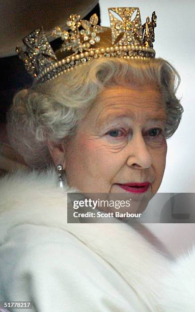 Britain's Queen Elizabeth II smiles as she looks out of the window of her horse drawn carriage as she leaves the Houses of Parliament after...